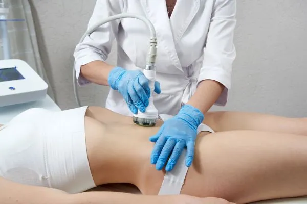 Lost the Weight but Not the Loose Skin? 2 woman having HIFU treatment on her stomach to combat loose skin Salford Priors following weight loss